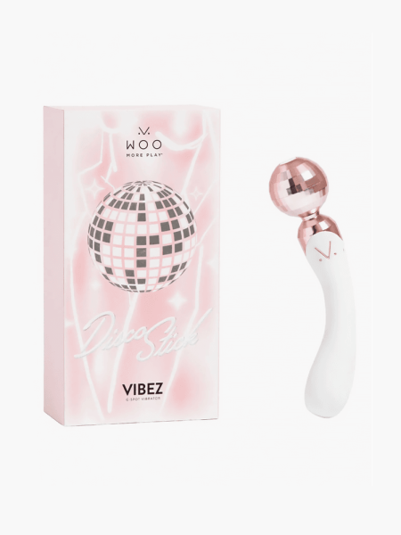Woo More Play Disco Stick G-Spot Vibrator in rose gold and white color way next to branded box packaging on light gray background